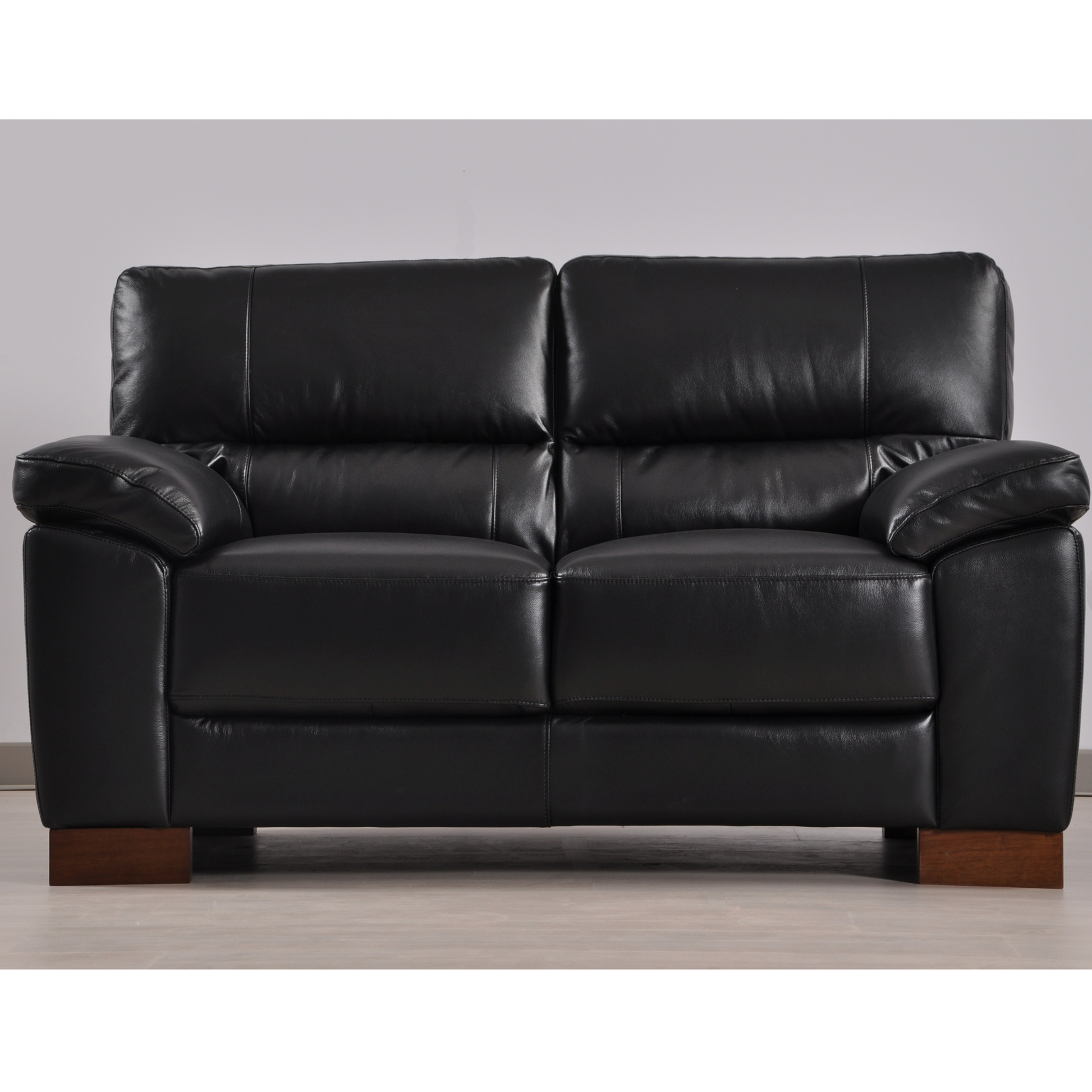 Dalmore Black 2 Seater – front-facing black two-seater sofa in a modern living room setting.