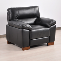 Angled view of the Dalmore Black Armchair in a modern room with soft lighting and neutral decor.
