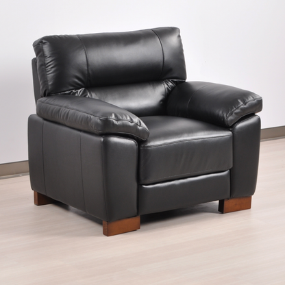 Angled view of the Dalmore Black Armchair in a modern room with soft lighting and neutral decor.