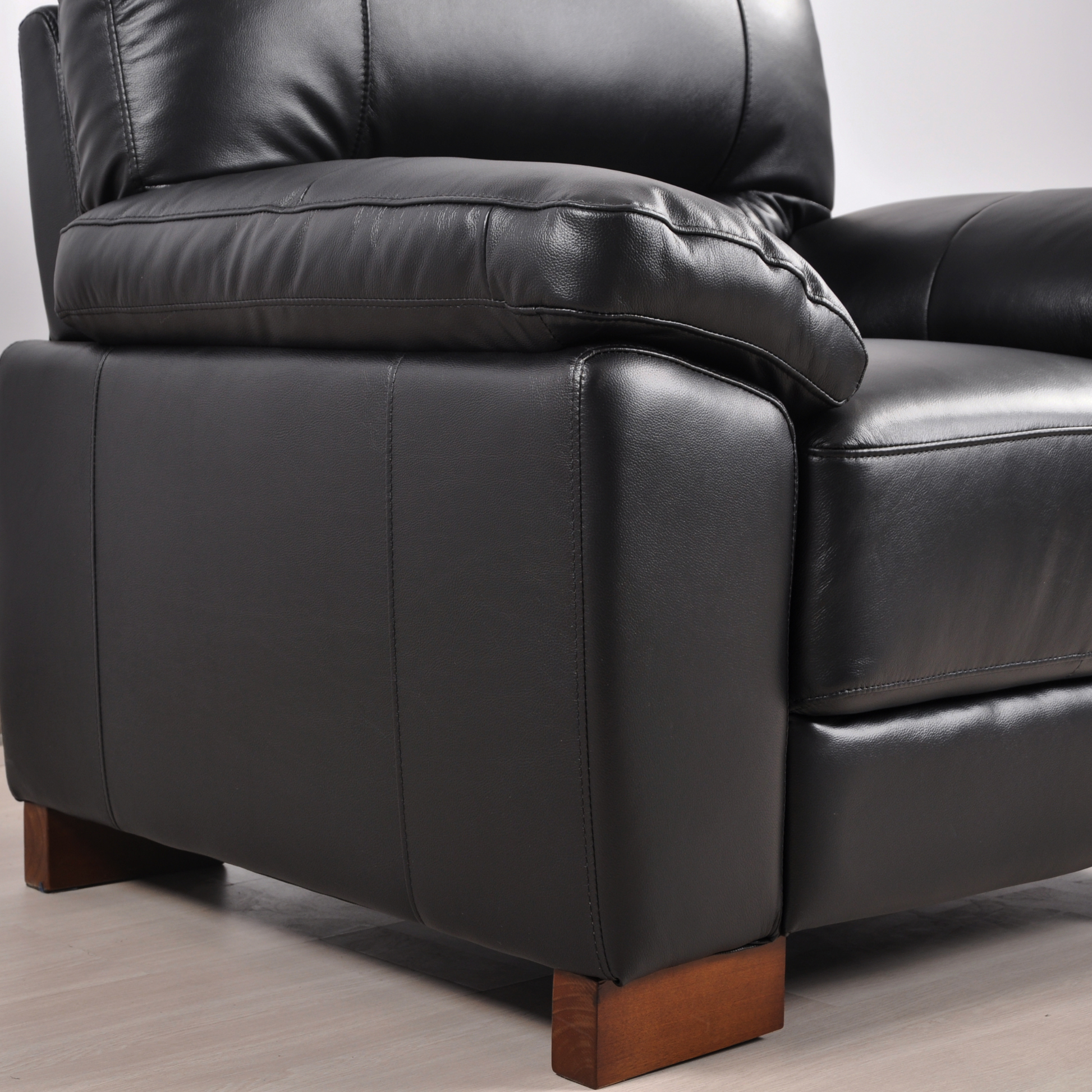 Close-up view of the Dalmore Black Armchair in a modern room setting with neutral tones and soft lighting.