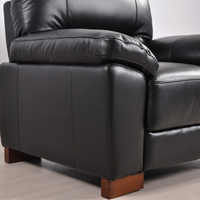 Close-up view of the Dalmore Black Armchair in a modern room setting with neutral tones and soft lighting.