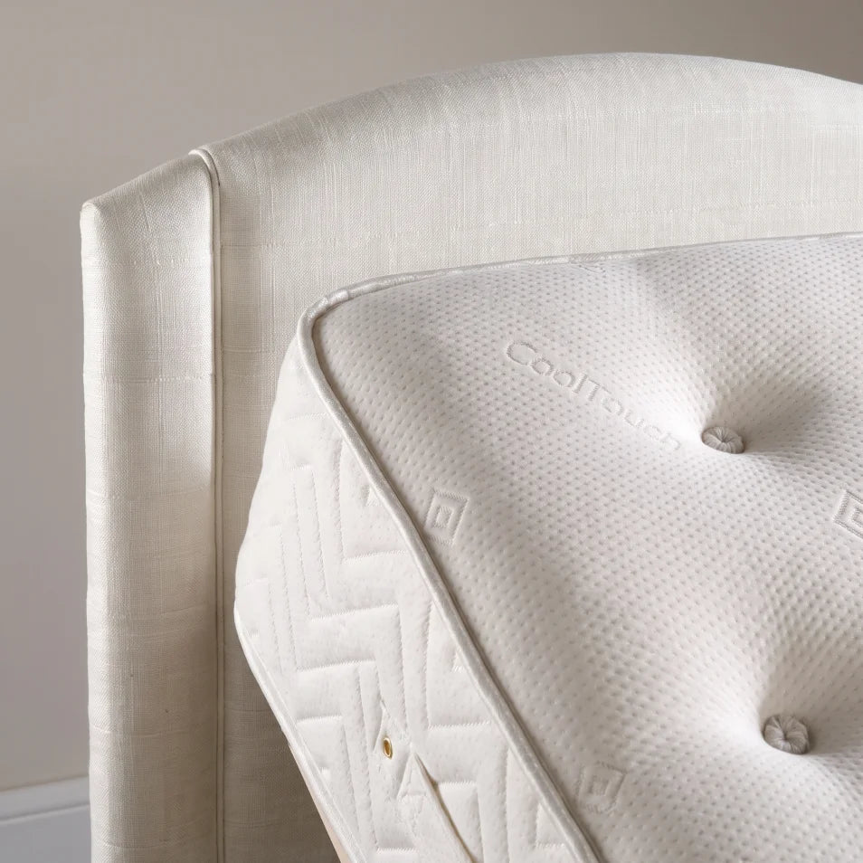 cream electric bed in a upright position