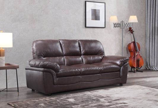 Brown leather sofa in a living room setting with a cello in the background.