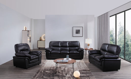 Black leather sofa set in a modern living room with large windows.