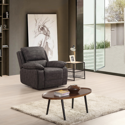 Gray armchair in a modern living room with a coffee table and decorative items.