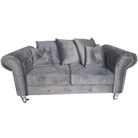 A gray velvet loveseat sofa with rolled arms, silver nailhead trim, and silver-toned legs, shown against a plain white background.