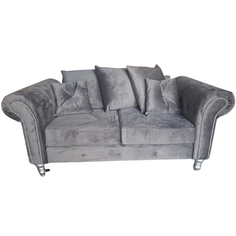 A gray velvet loveseat sofa with rolled arms, silver nailhead trim, and silver-toned legs, shown against a plain white background.