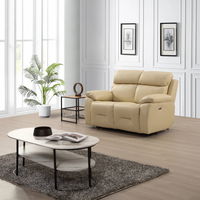 Renato cream two-seater sofa in a modern living room setting, styled with neutral décor, warm lighting, and contemporary furnishings.