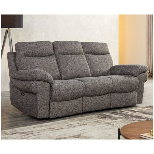 Gray reclining sofa in a living room setting with a lamp and coffee table.