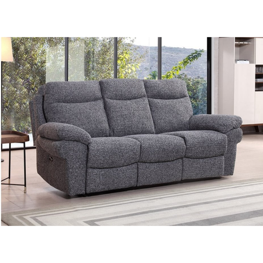 Gray sofa in a living room with large windows showing greenery outside