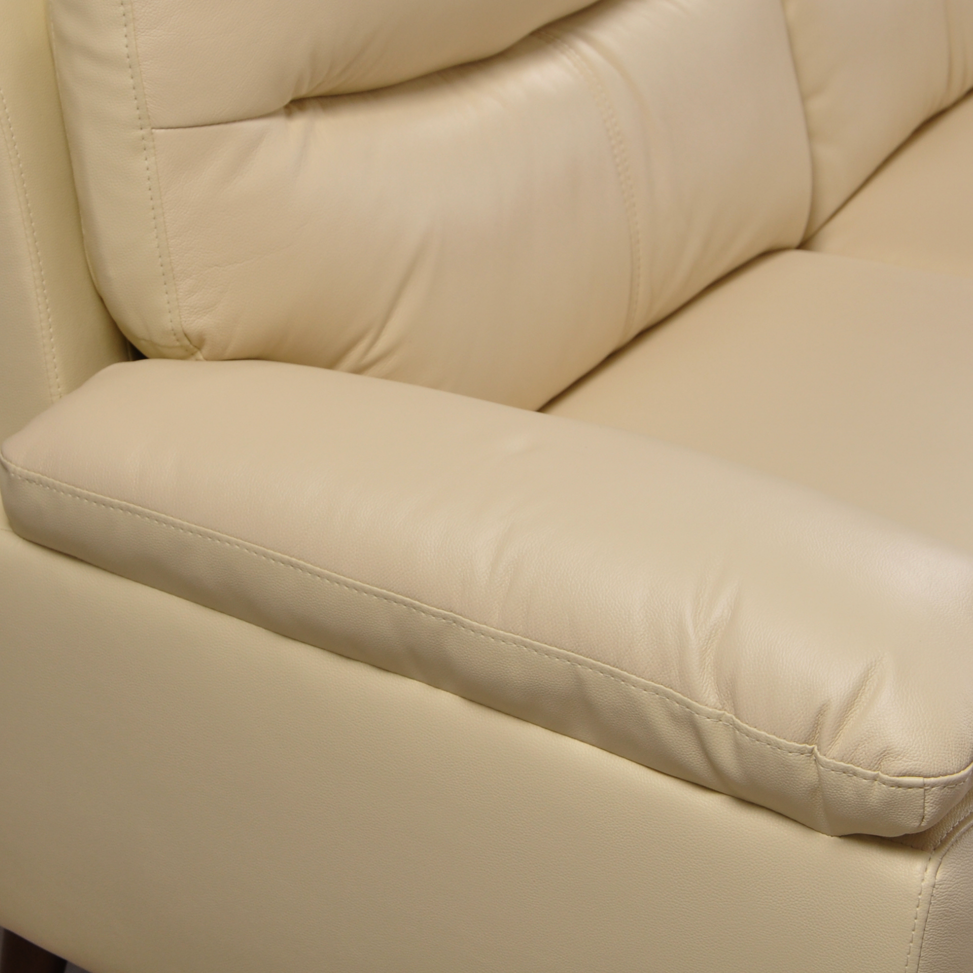Close-up of the Vantage Cream 2-Seater Sofa highlighting its soft cream upholstery and modern design details
