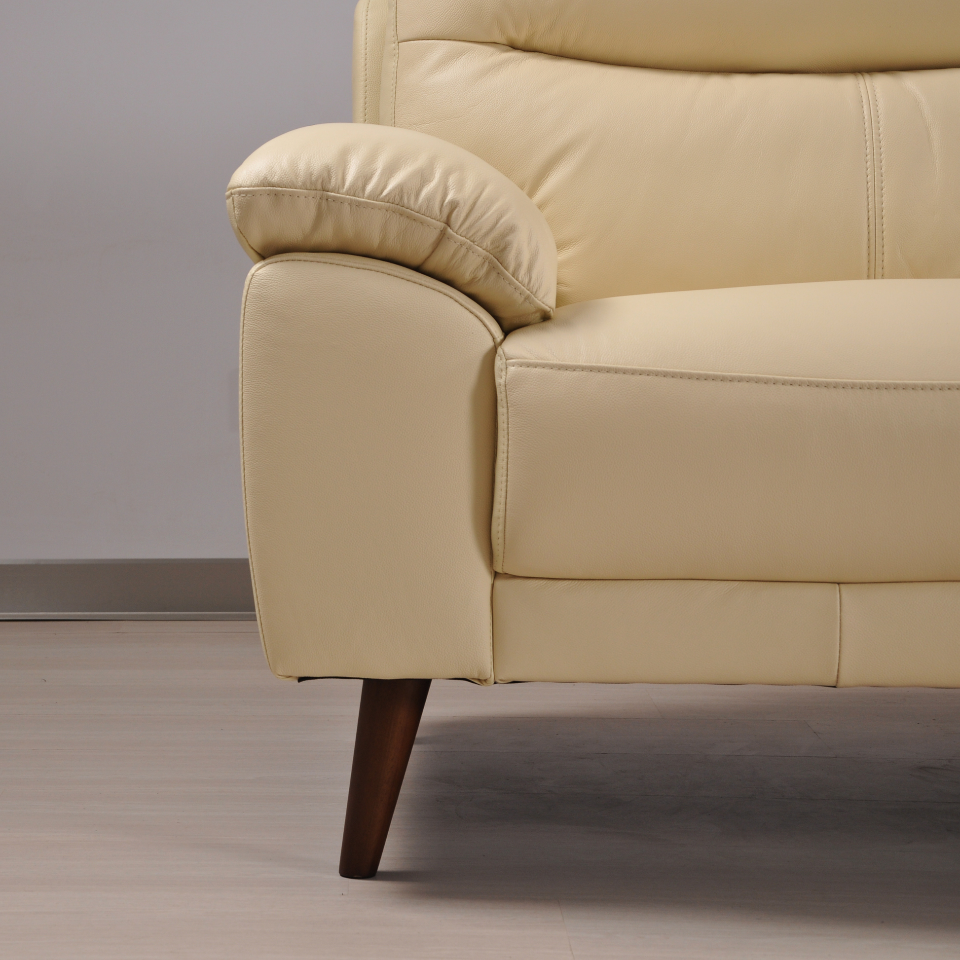 Close-up view of the Vantage Cream 2-Seater Sofa showcasing its soft cream upholstery and contemporary design features