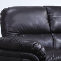 Close-up of a black leather recliner sofa against a white background