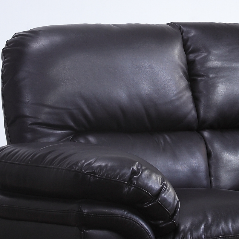 Close-up of a black leather recliner sofa against a white background
