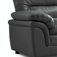 Close-up of a dark gray leather recliner chair on a white background