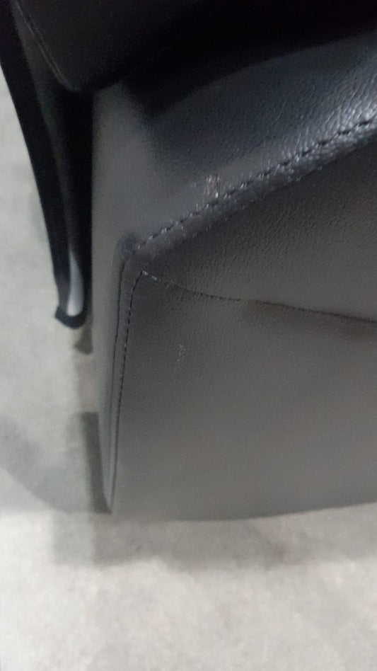 Close-up of a dark blue leather product on a light gray background