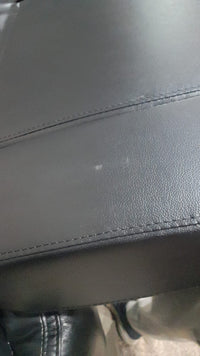 Close-up of a gray leather seat with visible stitching
