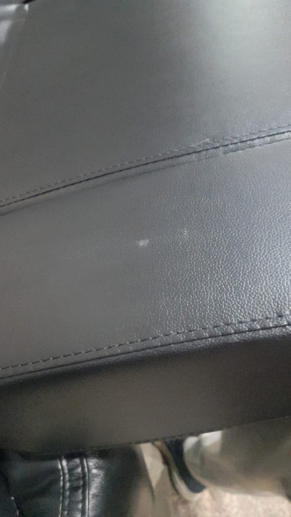 Close-up of a gray leather seat with visible stitching