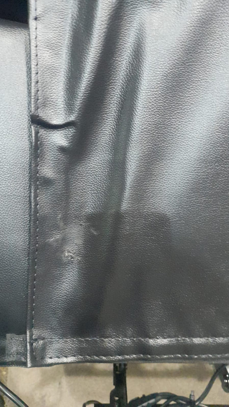 Close-up of black leather material with visible stitching