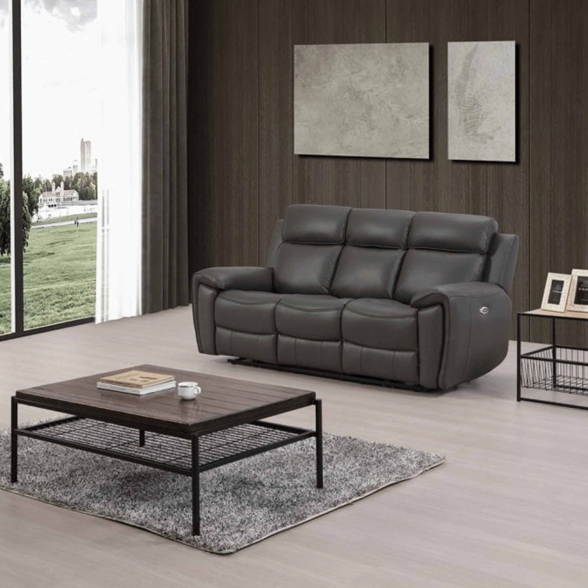 Gray leather sofa in a modern living room with a wooden coffee table and large windows.