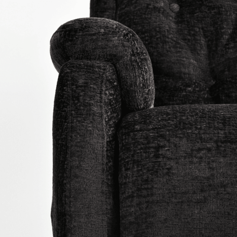 Close-up of a textured dark gray sofa with a white background