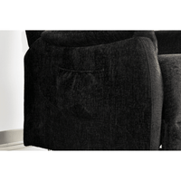 Close-up of a dark gray sofa with a pocket on the armrest.