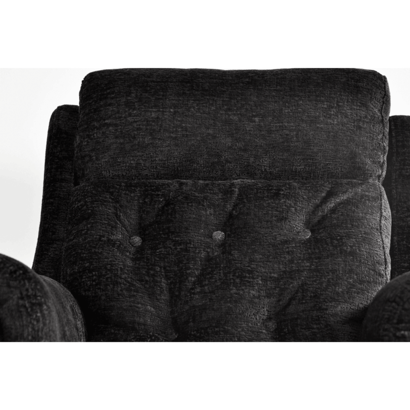 Close-up of a dark gray upholstered chair with button tufting on a white background