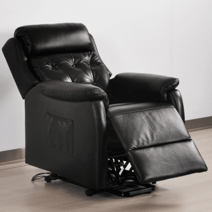 Black leather recliner chair on a light wooden floor with a white wall background