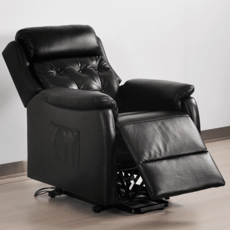 Black leather recliner chair on a light wooden floor with a white wall background