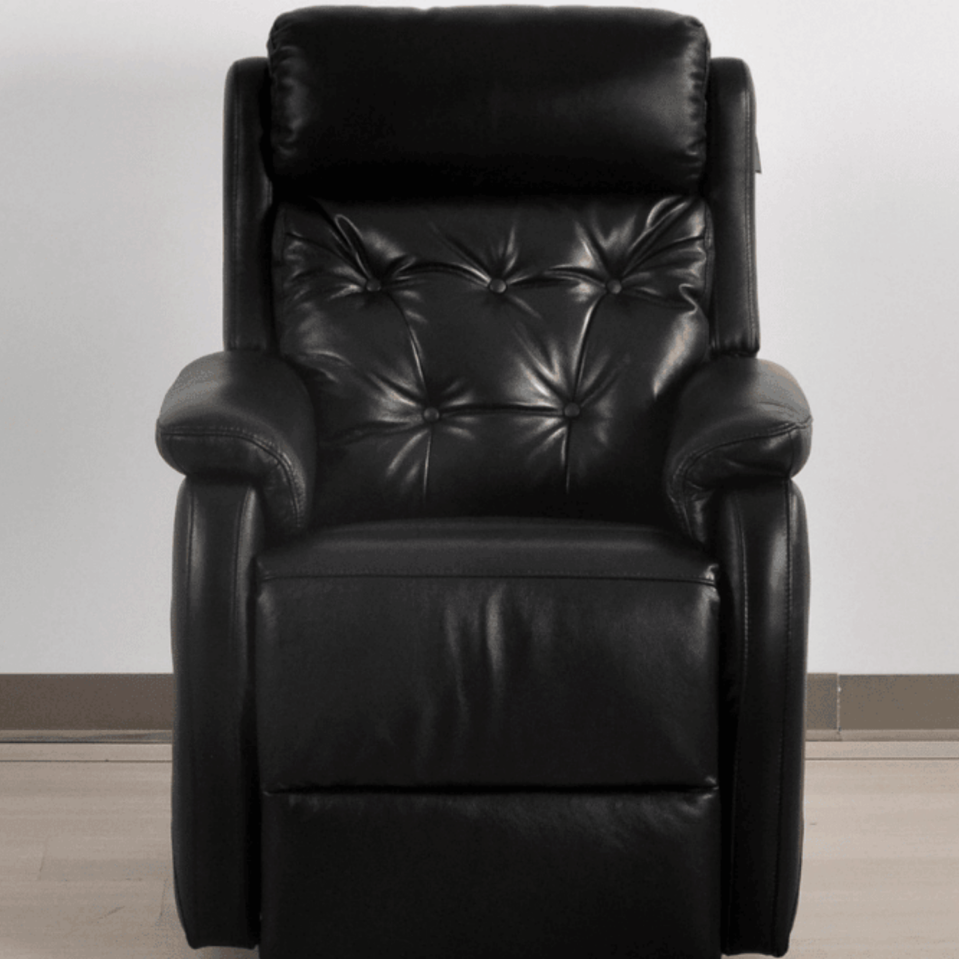 Black leather recliner chair on a plain background
