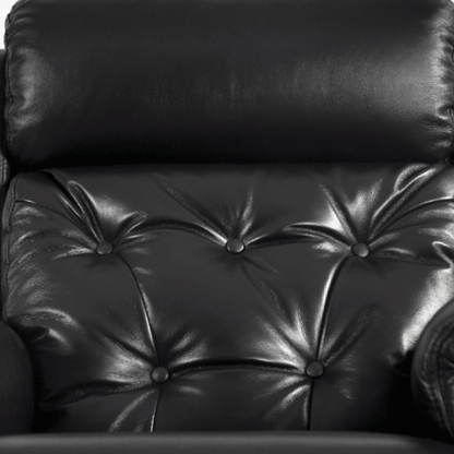 Close-up of a black leather armchair with buttoned backrest