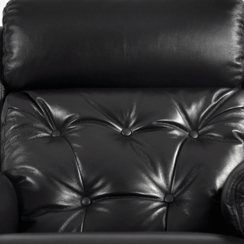 Close-up of a black leather armchair with buttoned backrest