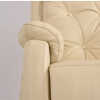 Close-up of a beige armchair with buttoned backrest on a light gray background