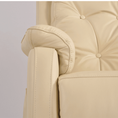 Close-up of a beige armchair with buttoned backrest on a light gray background