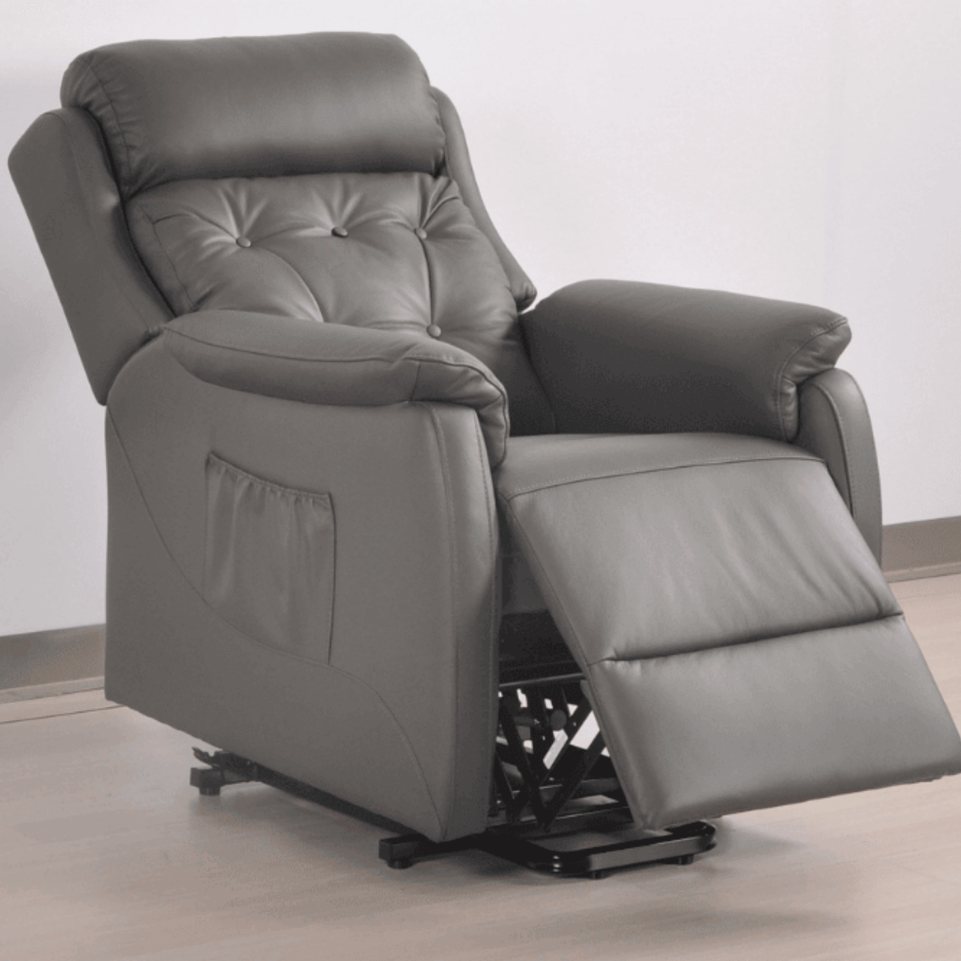Gray recliner chair on a light wooden floor with a white wall background