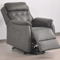 Gray recliner chair on a light wooden floor with a white wall background