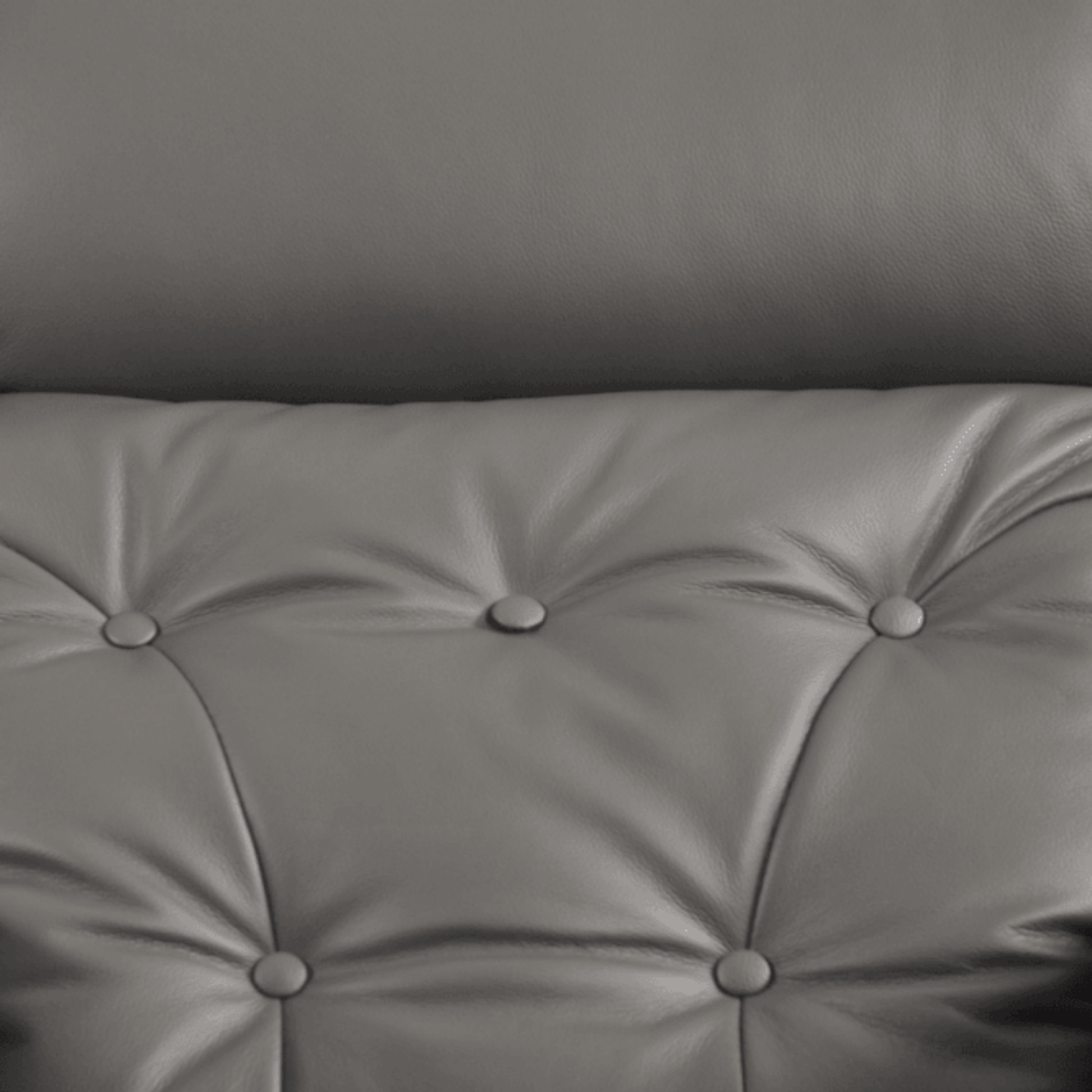Gray tufted cushion with button details on a plain background
