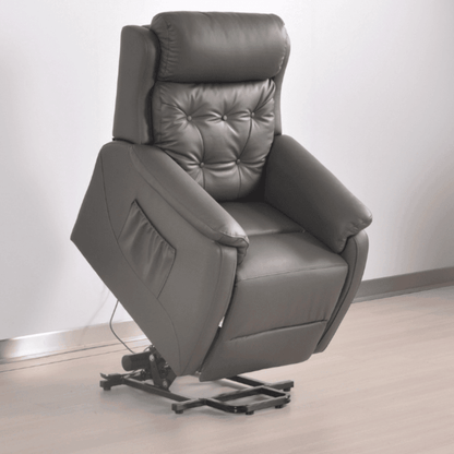 Gray leather recliner chair on a light wooden floor with a white wall background