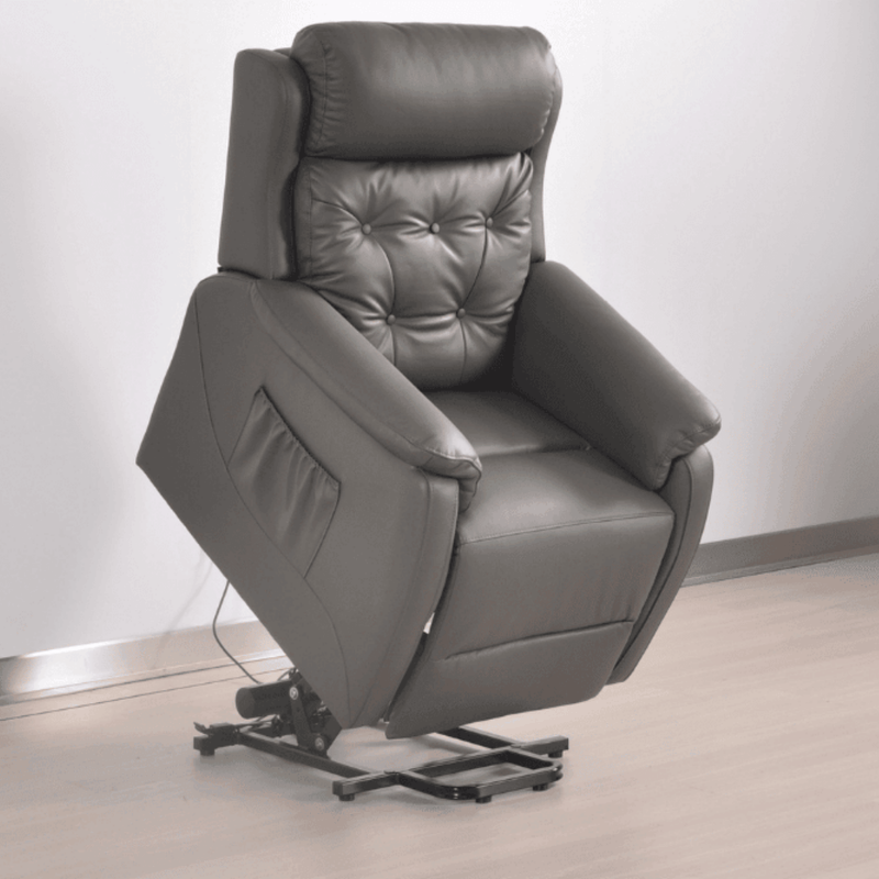 Gray leather recliner chair on a light wooden floor with a white wall background
