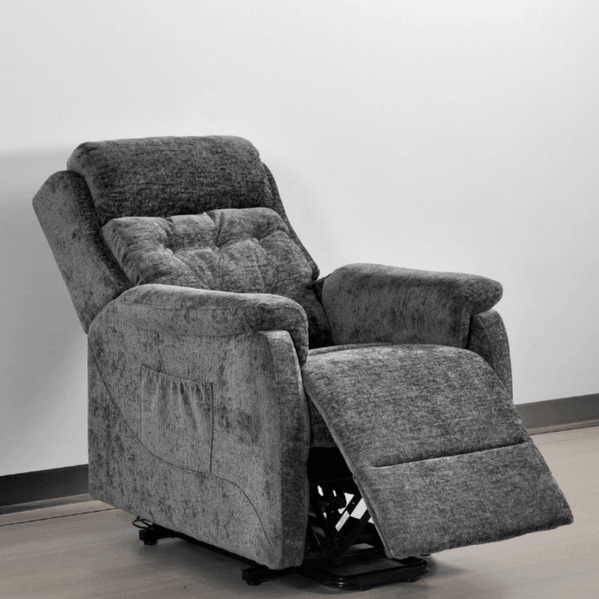 Gray recliner chair on a light wooden floor with a white wall background