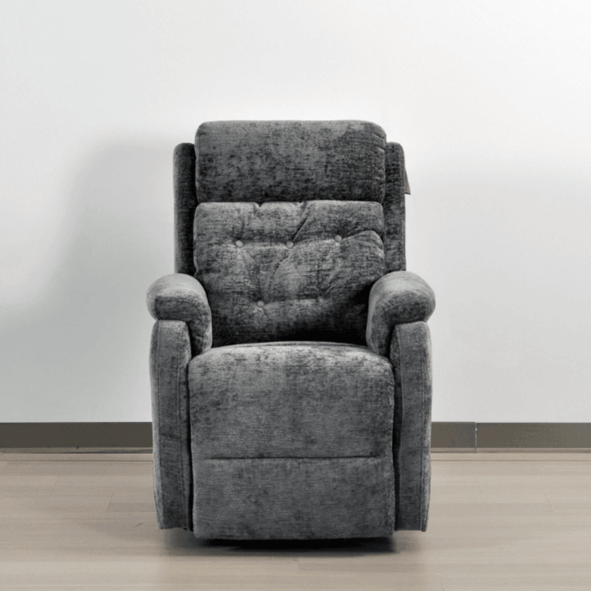 Gray recliner chair against a white wall