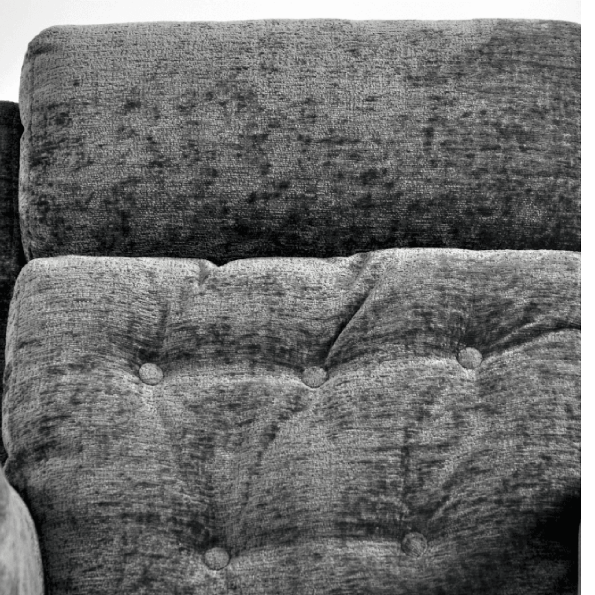 Close-up of a textured fabric surface with tufted design