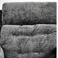 Close-up of a textured fabric surface with tufted design