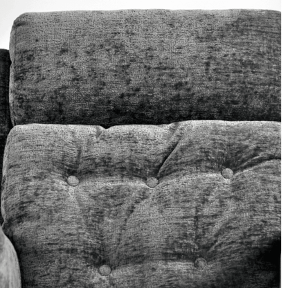 Close-up of a textured fabric surface with tufted design