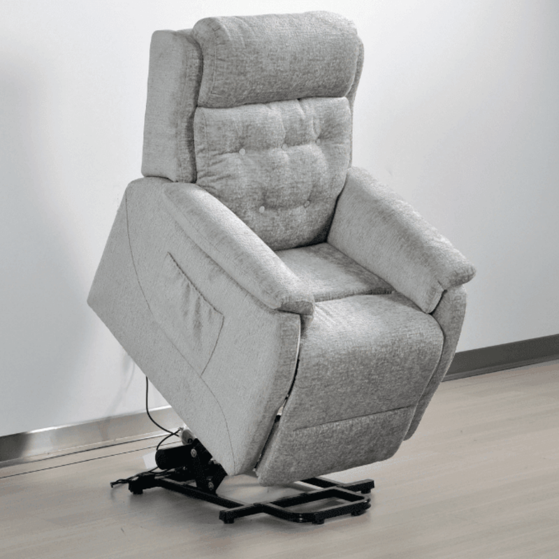 Gray recliner chair on a wooden floor with a white wall background