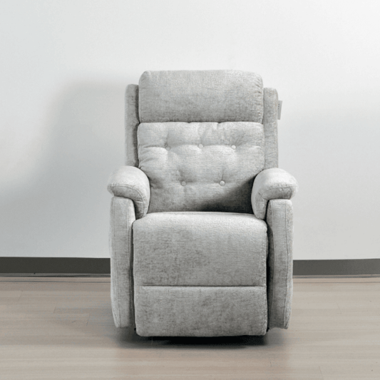 Gray recliner chair on a wooden floor with a white wall background