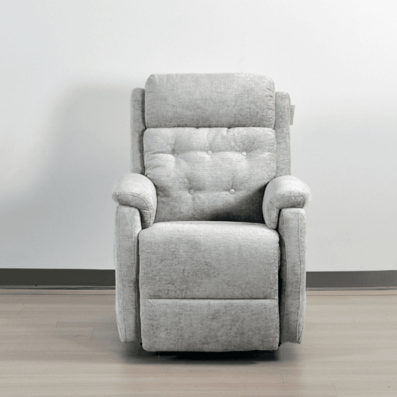 Gray recliner chair on a wooden floor with a white wall background