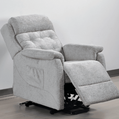 Gray recliner chair with armrests and footrest on a light gray background