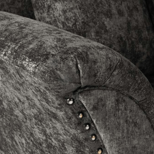 Close-up of a textured gray fabric surface with decorative studs.