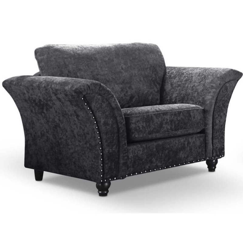 Gray upholstered armchair with nailhead trim on a white background